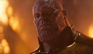 Avengers: Infinity War Thanos looks melancholy in a glowing environment