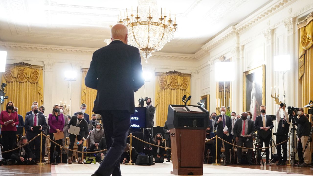 Joe Biden arrives for a press conference marking his first year in the White House