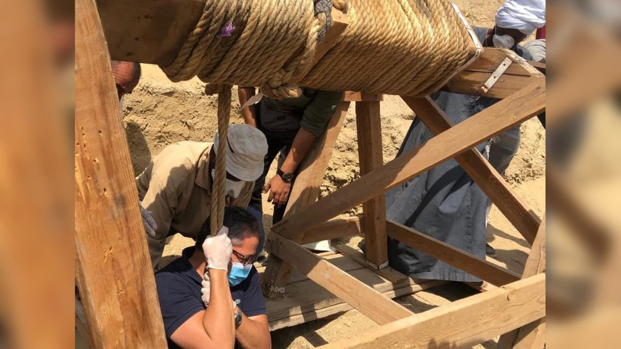 The excavation team had to carefully lower themselves in the burial well.