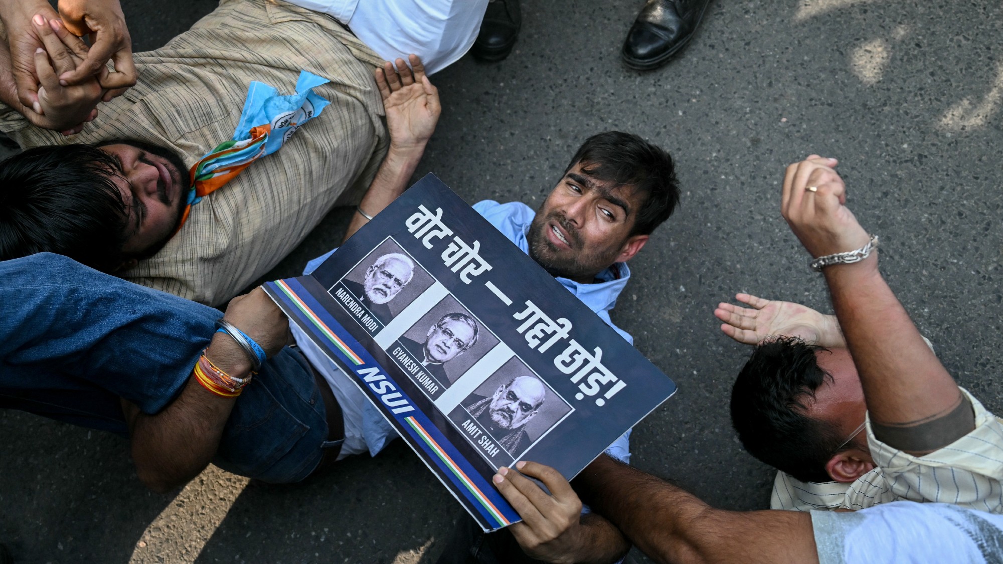 Security personnel detain student activists during a protest in New Delhi