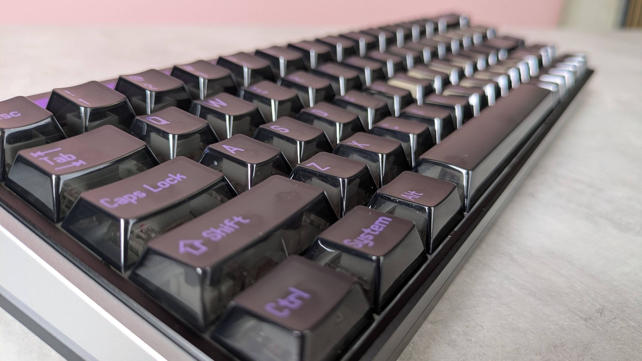 Side view of keys on MelGeek Made68 Ultra V2, on desk with pink wall in background
