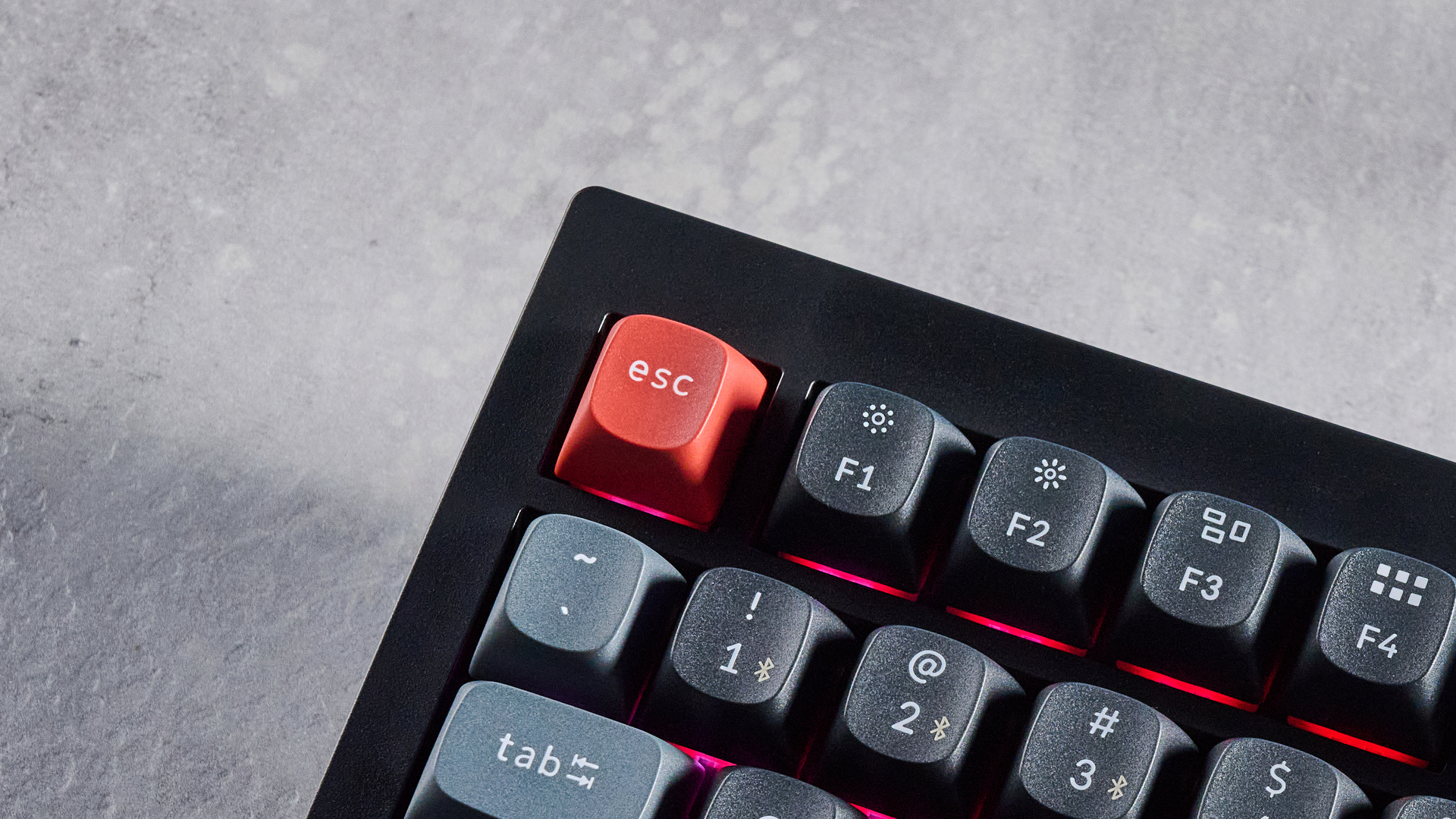 Keychron V3 Ultra 8K photographed on a grey table top in front of a blue background