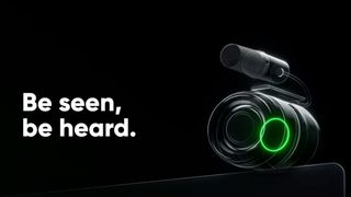 Insta360 teaser art with 'Be seen, be heard' text next to a graphic of what looks like a camera lens and a mic with a glowing green ring