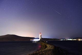 A Geminid seen above a lighthouse in Vladivostok, Russia, in December 2018.