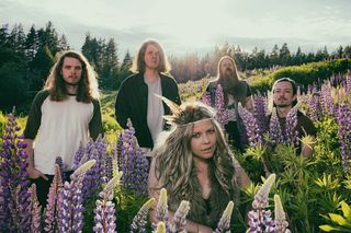 Swedish band Gaupa posing in a park with flowers
