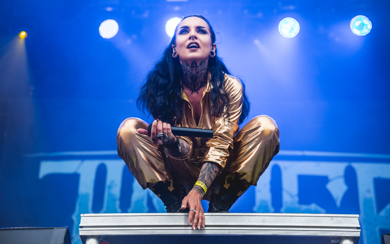 Tatiana on stage in a gold jumpsuit