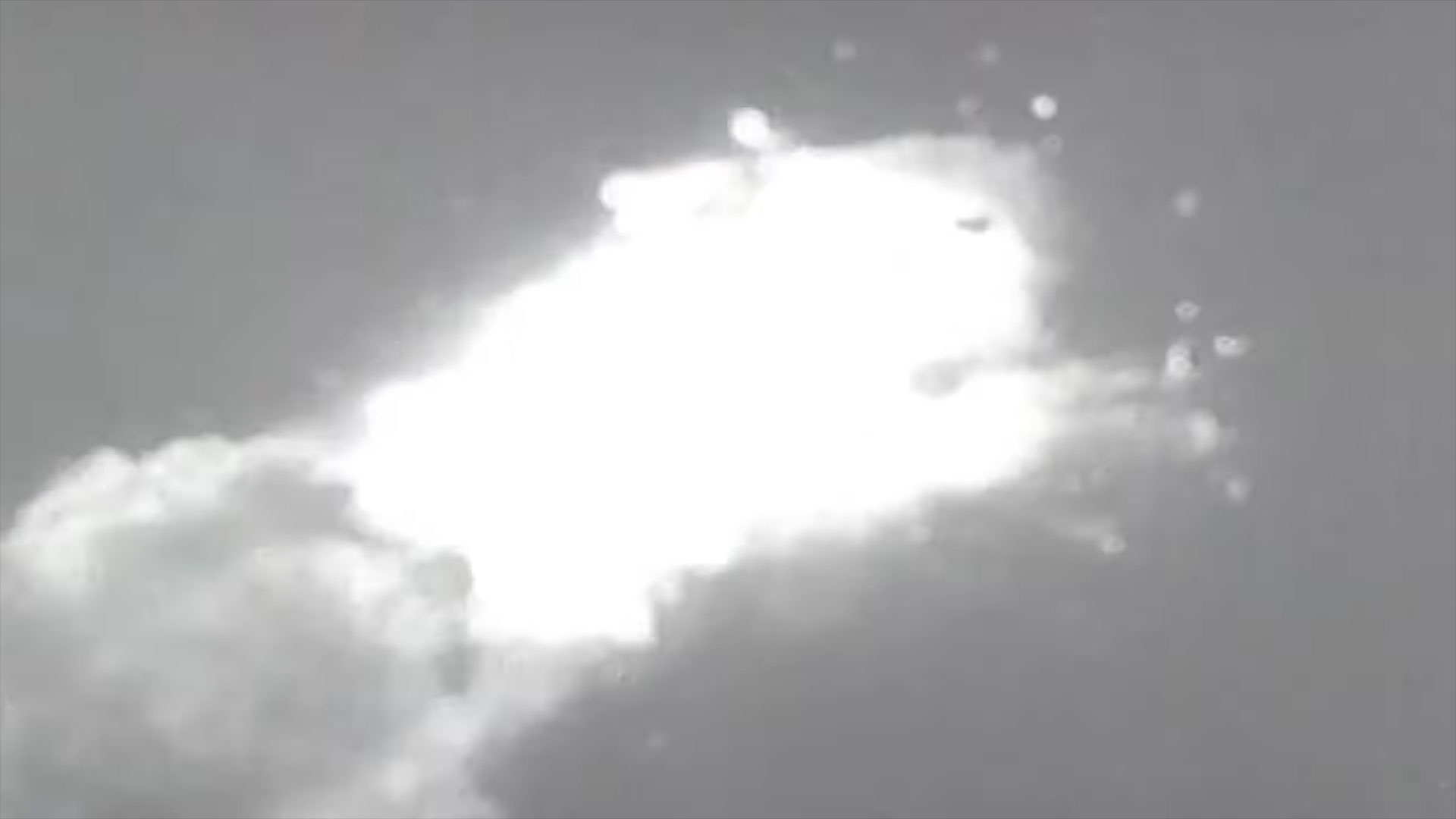 a mid-air explosion creates a large plume of debris and smoke
