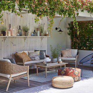 outdoor living room with wall shelf and planters