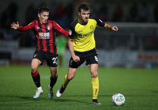 Bournemouth’s Harry Wilson and Burton’s Scott Fraser battle for the ball