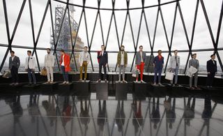 Models stood on simple black blocks that blended with the floor, with the London skyline and the building's iconic architecture serving as a perfect backdrop.