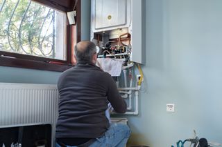 An engineer working on a tank water heater