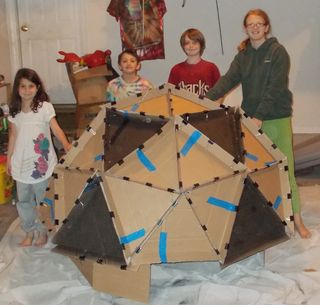 Candy, Jimmy, Michael and Dawn pose with the planetarium they built.