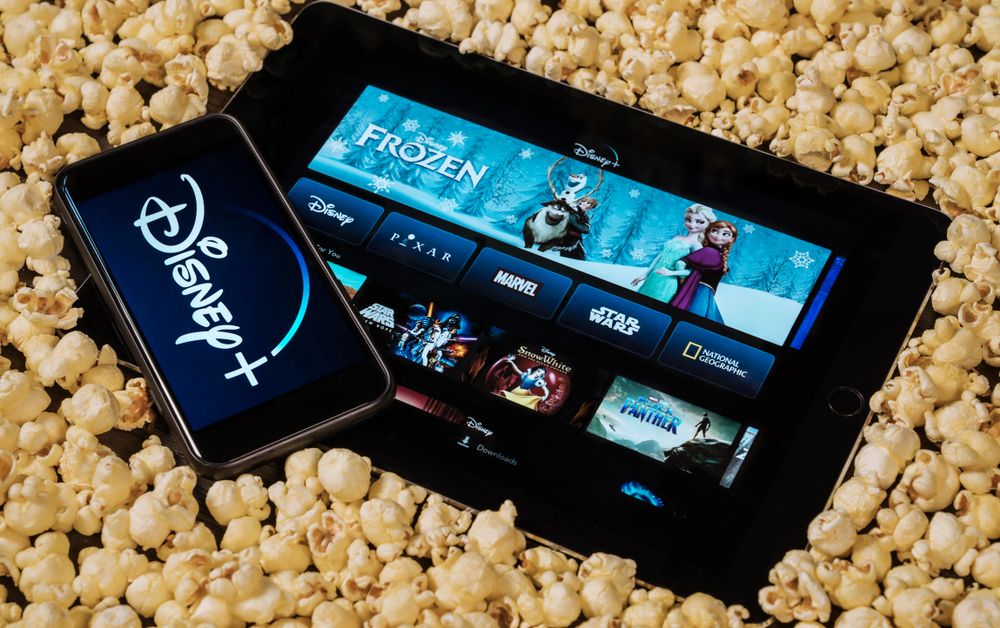 The Disney+ app on two devices sitting in popcorn 