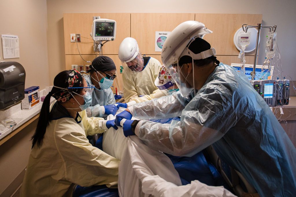 Health care workers prone a COVID-19 patient in the intensive care unit overflow area at Providence Holy Cross Medical Center in Mission Hills, California, on Feb. 5, 2021. 