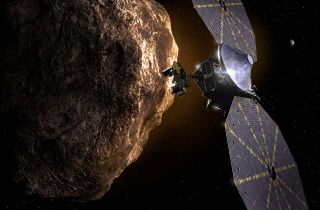 An artist's depiction of the Lucy spacecraft studying an asteroid.