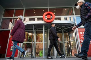 Pedestrians wearing protective masks pass in front of a Target Corp. store in San Francisco, California, U.S., on Monday, Mar. 1, 2021.