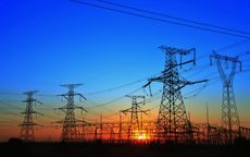 The silhouette of the evening electricity transmission pylon