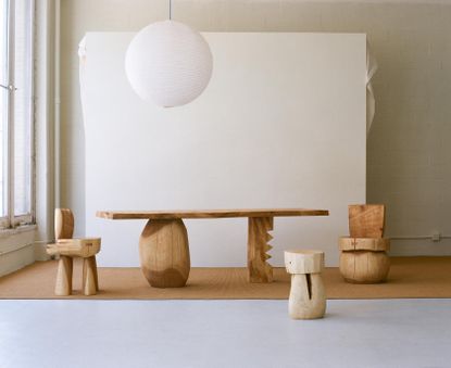 Wooden table, chairs and stool with chunky volumes