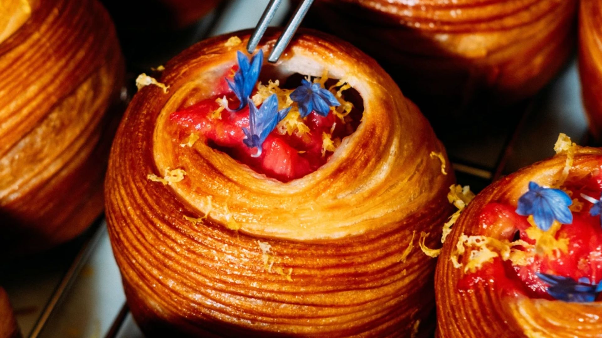 an image of a pastry on offer at cafe 1922, a croissant style bin with stewed fruit on top