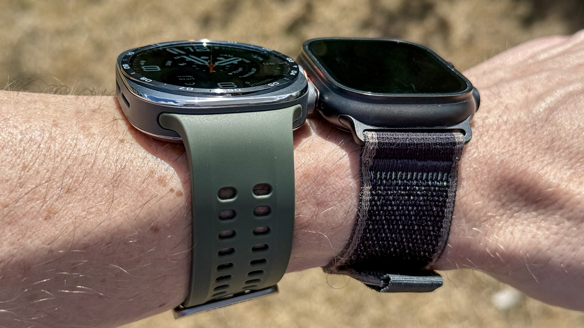 The Samsung Galaxy Watch Ultra 2 and Apple Watch Ultra 2 on a wrist outside