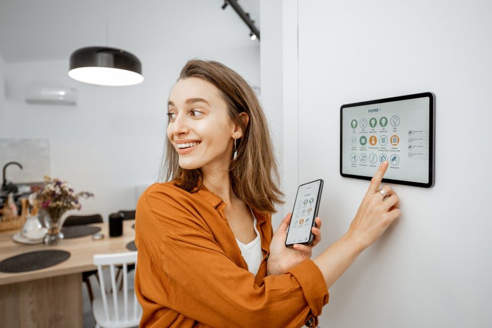 woman controlling home digital touch screen