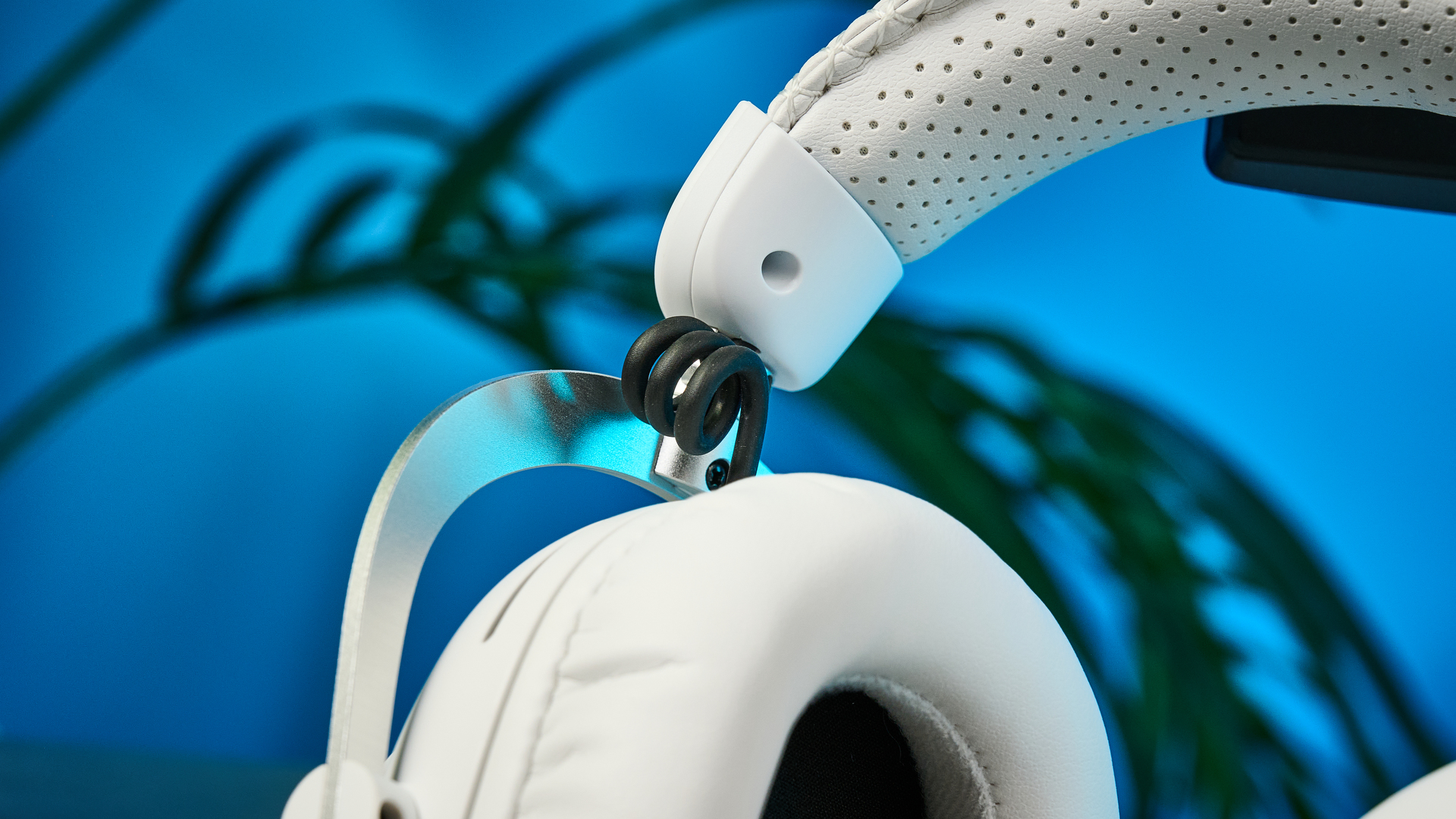 The Logitech G Pro X3 Lightspeed headset in white, on a stone surface.