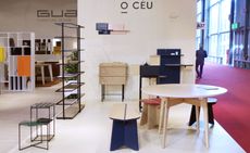 View of the O CÉU stand at the Salone del Mobile exhibition featuring multiple pieces of furniture