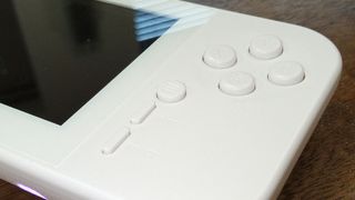 Evercade EXP review; a white handheld games console on a wooden table
