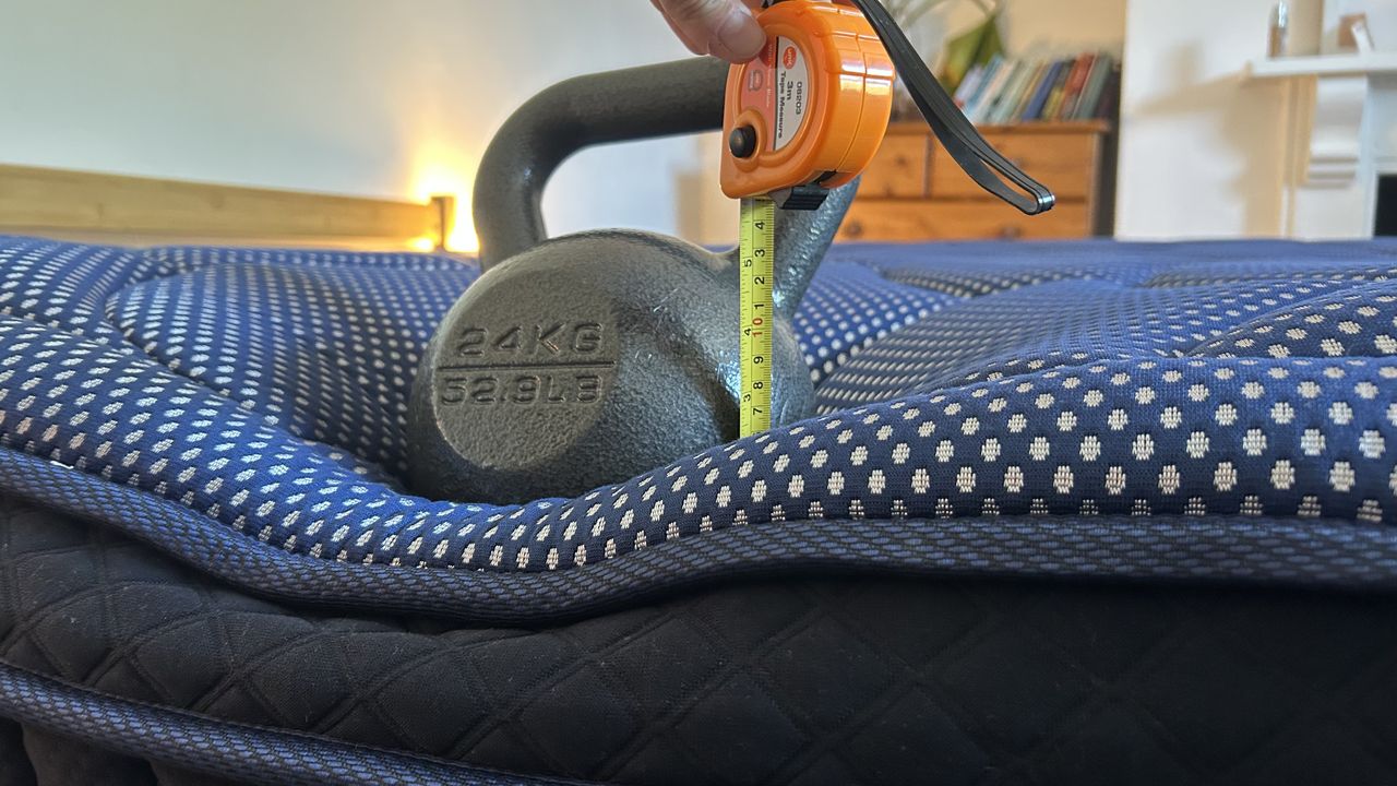 A weight resting on the edge of the DreamCloud Luxe Memory Foam mattress to measure edge support