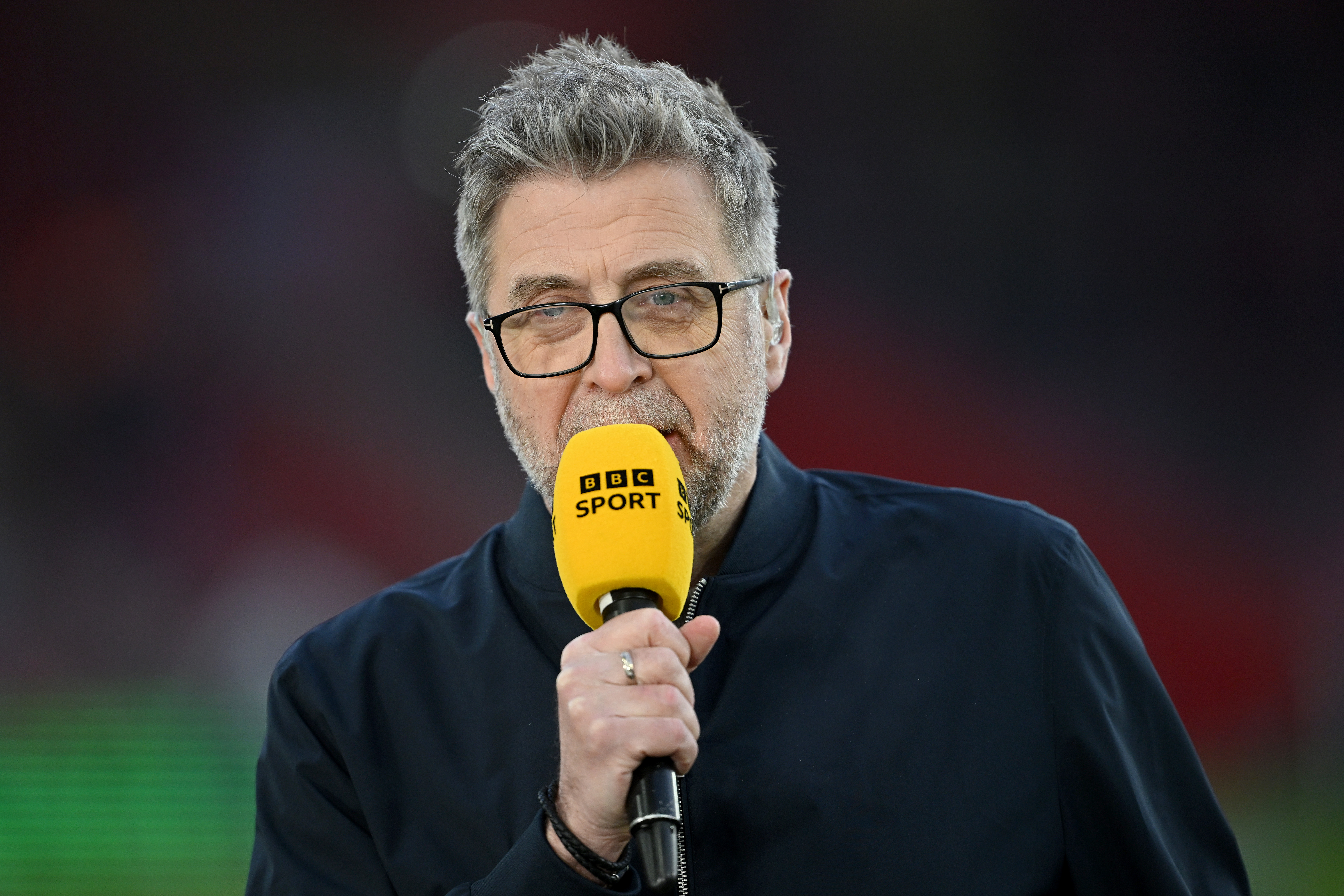 Mark Chapman speaks into a BBC Sports microphone in 2026