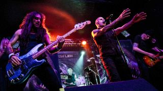 Steve Harris performing onstage with British Lion in 2013