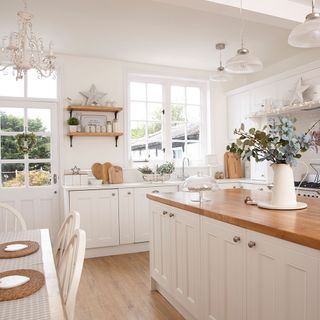 room with wooden worktop white wall and white chair