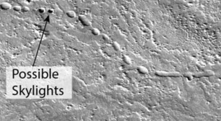 An image from the Mars Reconnaissance Orbiter shows a possible lava tube on Mars near the southern flank of the Martian volcano Arsia Mons.