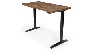 Uplift V2 standing desk review: An image showing the desk with black legs and a dark walnut top