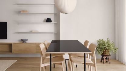 minimalist dining room with wood table with black top, wood chairs and white shelves