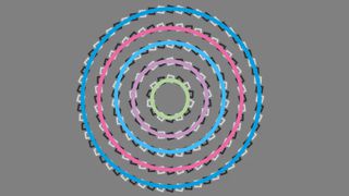 An optical illusion showing what appears to be a spiral made of black and white rectangles, with coloured circles overlaid to illustrate that it actually shows concentric circles
