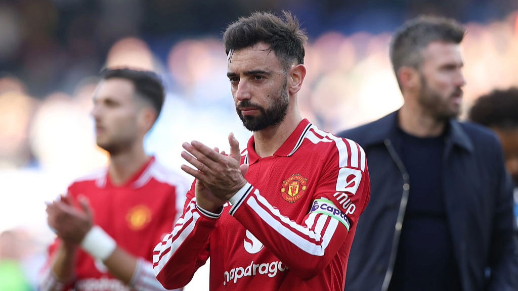 Bruno Fernandes, wearing the red of Man Utd, applauds the fans after a Premier League game.