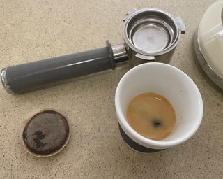 A cup of espresso prepared using the Smeg coffee maker and coffee pods