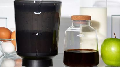 An OXO Brew Compact Cold Brew Coffee Maker on a refrigerator shelf