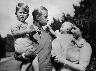 Royal British couple, Queen Elizabeth II, and her husband Philip, Duke of Edinburgh, with their two children, Charles, Prince of Wales (L) and Princess Anne (R), circa 1951