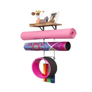 A wooden and metal yoga mat holder with mats on it