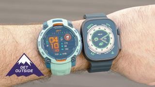Close-up of the Apple Watch Ultra 2 (left) next to the Garmin Instinct 3 (right) on a user's wrist