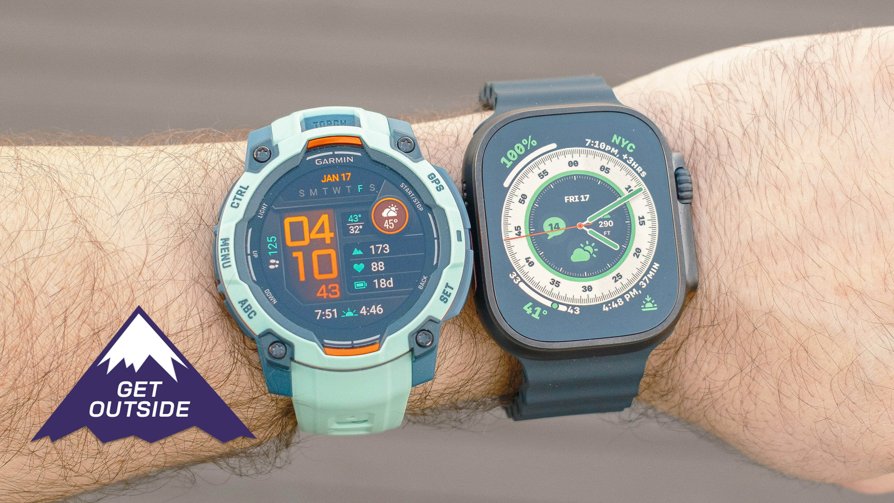 Close-up of the Apple Watch Ultra 2 (left) next to the Garmin Instinct 3 (right) on a user&#039;s wrist