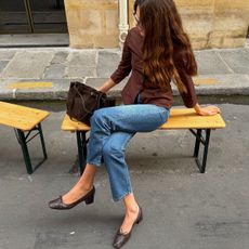 Woman in jeans and a brown top