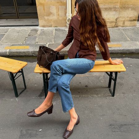 Woman in jeans and a brown top