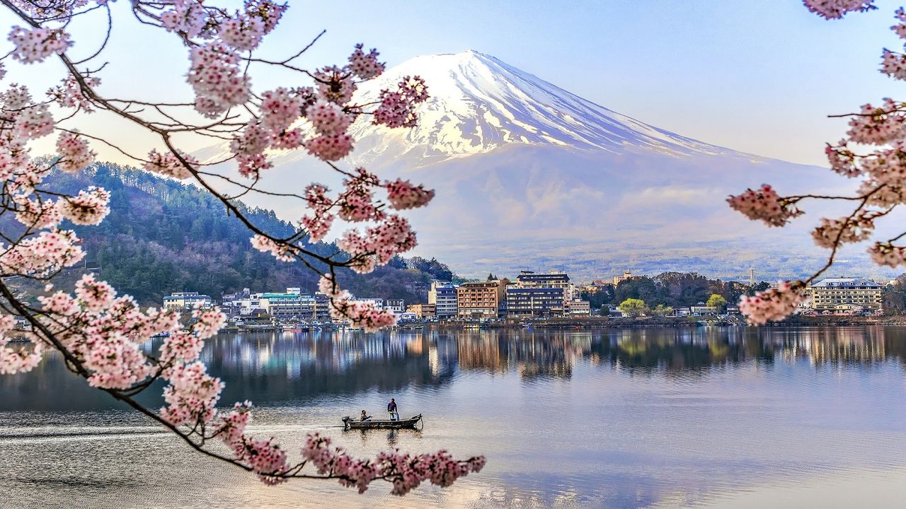 Kawaguchiko Lake in Japan during cherry blossom, one of woman&amp;home&#039;s best places to travel in 2023