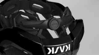 A rear-on view of a black Kask Protone Icon helmet, showing the new octofit system