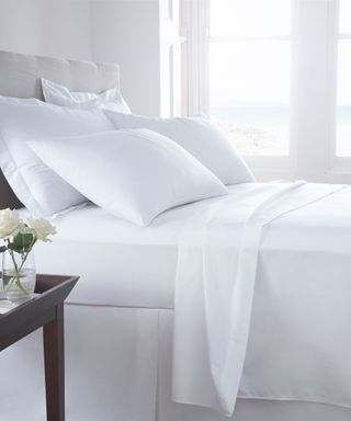white bedding and pillows in bedroom