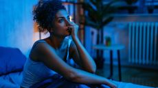 a woman with insomnia sits in bed