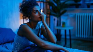 a woman with insomnia sits in bed